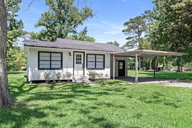 590 Parks St, Silsbee, TX 77656 - ranch-style house featuring a front lawn, roof with shingles, entry steps, and a carport