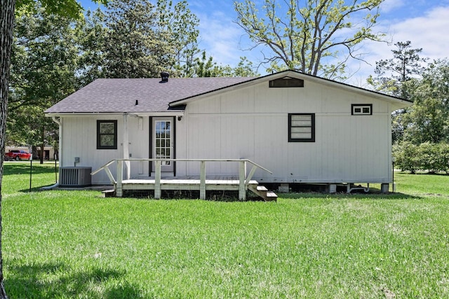 590 Parks St, Silsbee, TX 77656 - rear view of house with a yard, central AC unit, a wooden deck, and a shingled roof