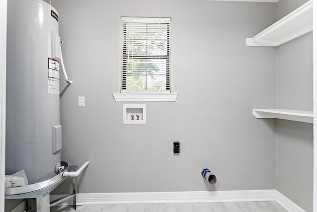 590 Parks St, Silsbee, TX 77656 - clothes washing area featuring laundry area, washer hookup, hookup for an electric dryer, water heater, and baseboards