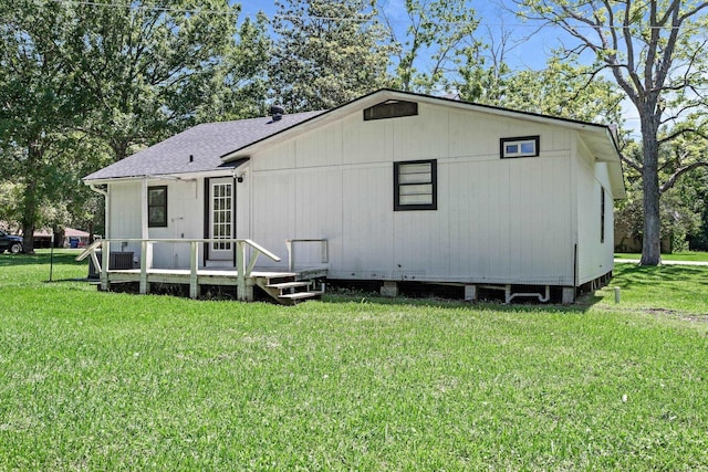 590 Parks St, Silsbee, TX 77656 - back of house featuring a yard, a wooden deck, and roof with shingles