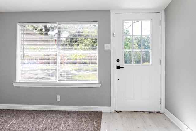 590 Parks St, Silsbee, TX 77656 - doorway with light wood-type flooring, plenty of natural light, and baseboards