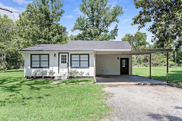 590 Parks St, Silsbee, TX 77656 - view of front of home featuring a front lawn, driveway, roof with shingles, and a carport