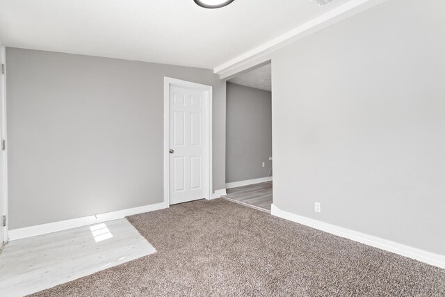 590 Parks St, Silsbee, TX 77656 - empty room with carpet floors, beamed ceiling, and baseboards