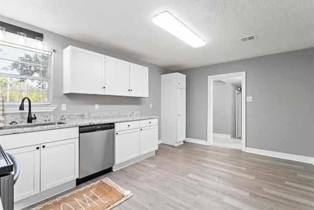 590 Parks St, Silsbee, TX 77656 - kitchen featuring a sink, a textured ceiling, white cabinets, stainless steel dishwasher, and light wood-style floors