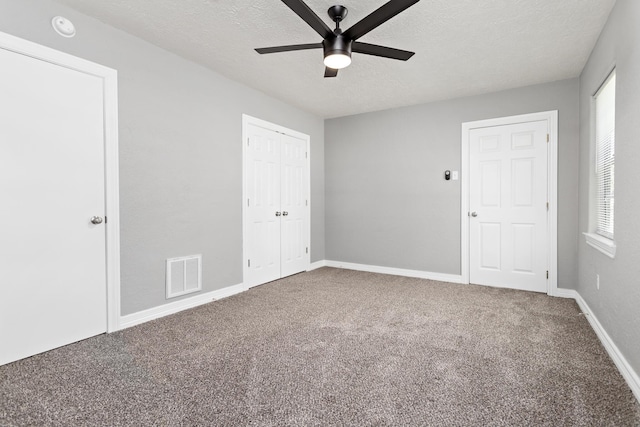 590 Parks St, Silsbee, TX 77656 - unfurnished bedroom with a textured ceiling, carpet flooring, a closet, and visible vents