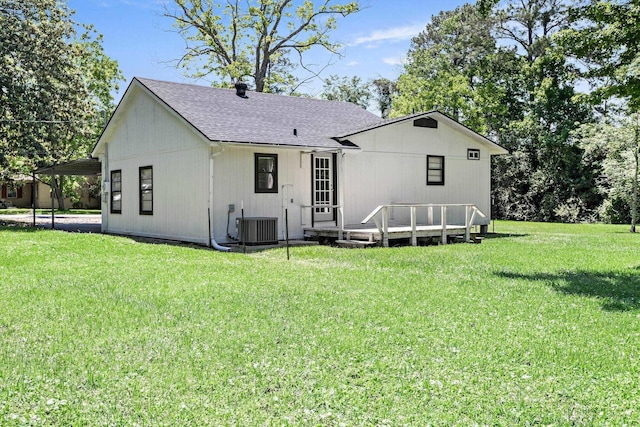 590 Parks St, Silsbee, TX 77656 - back of property featuring central AC unit, a wooden deck, a shingled roof, and a lawn