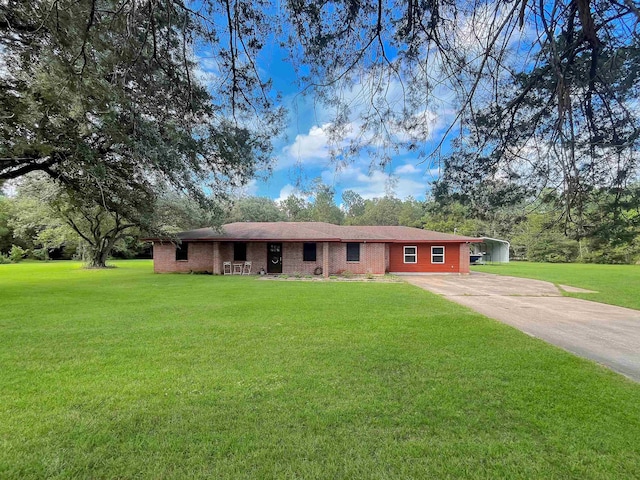 ranch-style house featuring a front yard and a carport