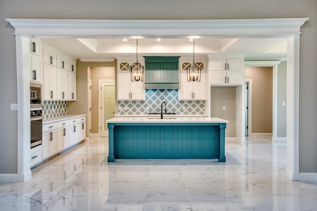 kitchen with light countertops, stainless steel oven, a raised ceiling, a sink, and a notable chandelier