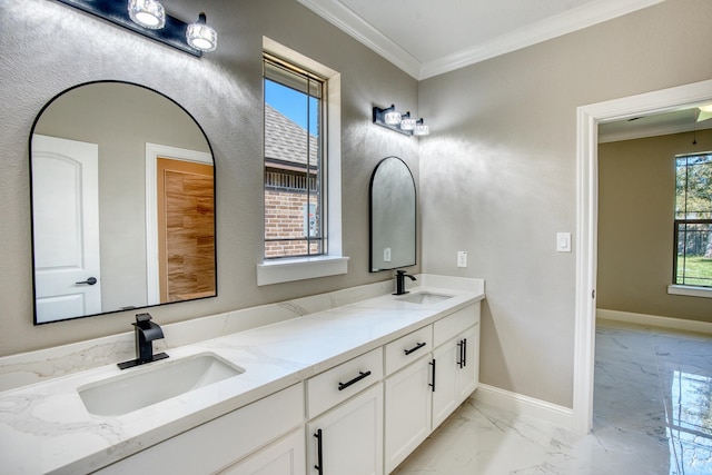 bathroom featuring marble finish floor, baseboards, ornamental molding, and a sink