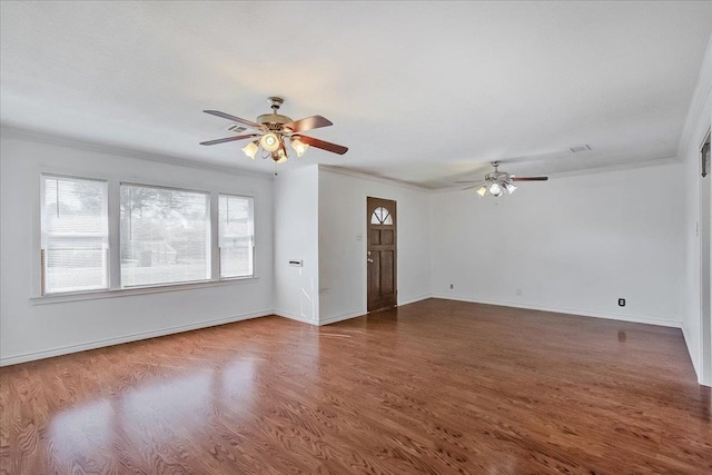 spare room with dark hardwood / wood-style floors, ceiling fan, and ornamental molding