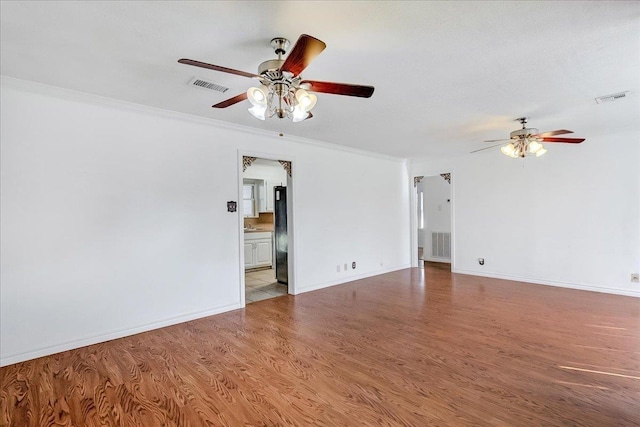 unfurnished room with ceiling fan, hardwood / wood-style floors, and ornamental molding