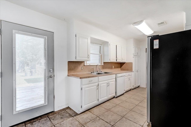 kitchen with white cabinets, decorative backsplash, stainless steel fridge, and dishwasher