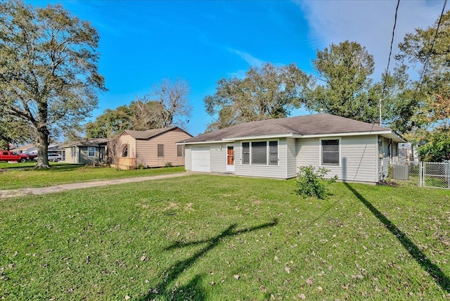 view of front of home with a front yard and a garage