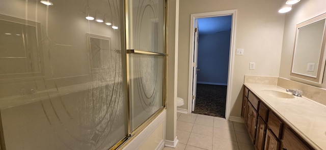 full bathroom featuring tile patterned floors, vanity, toilet, and bath / shower combo with glass door