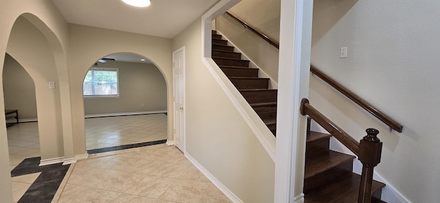 stairway with tile patterned floors