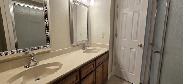 bathroom with tile patterned flooring, vanity, and an enclosed shower