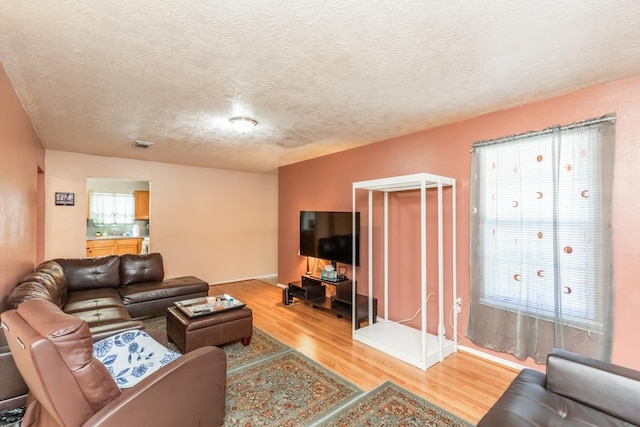 1007 Ewing St, Beaumont, TX 77701 - living area with wood finished floors and a textured ceiling