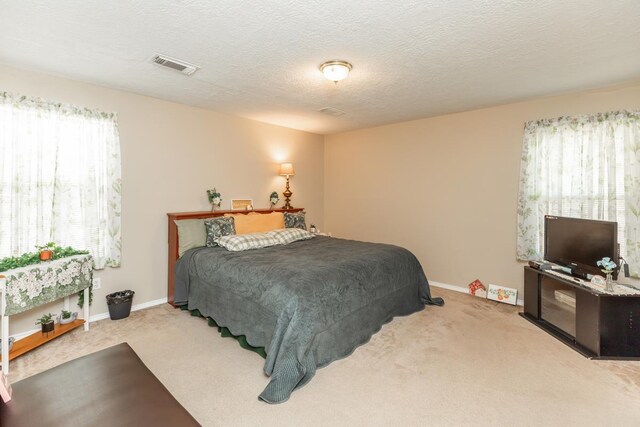 1007 Ewing St, Beaumont, TX 77701 - carpeted bedroom with baseboards and a textured ceiling