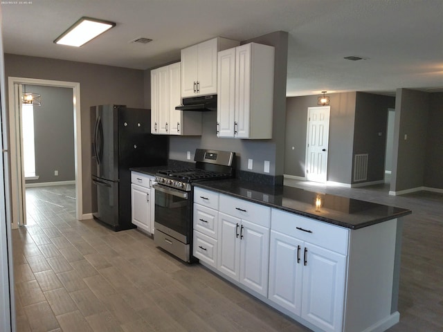 kitchen with white cabinets, light wood-type flooring, and stainless steel gas stove