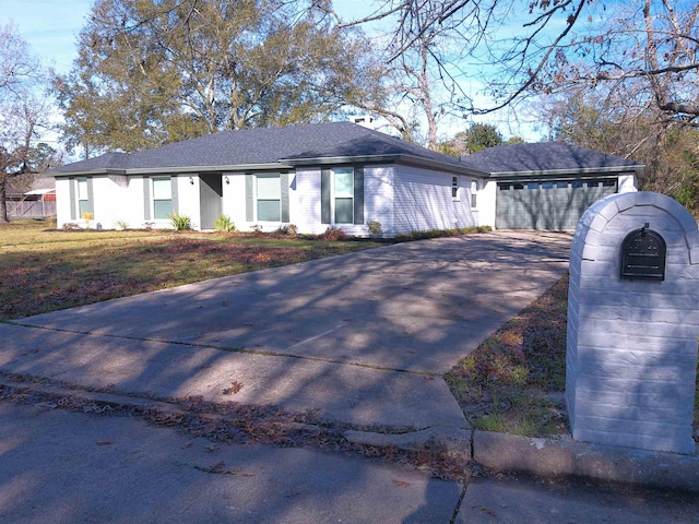 single story home featuring a garage and a front yard