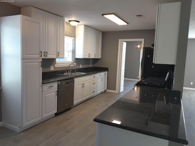 kitchen featuring dishwasher, sink, white cabinets, black fridge, and light wood-type flooring