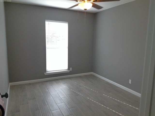 spare room featuring hardwood / wood-style floors and ceiling fan