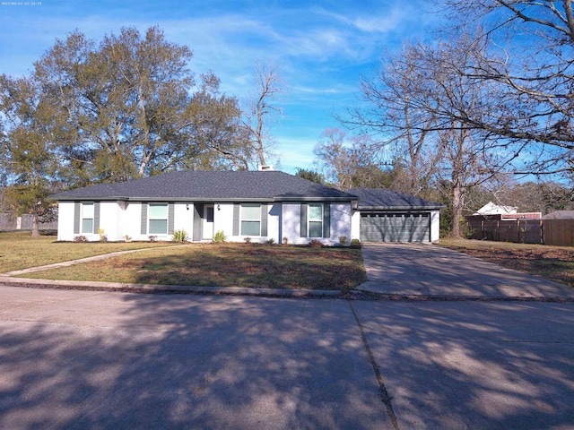 single story home featuring a garage and a front lawn