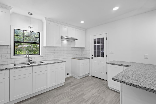 4247 Lansing Ave, Port Arthur, TX 77642 - kitchen with light stone counters, backsplash, white cabinets, and recessed lighting