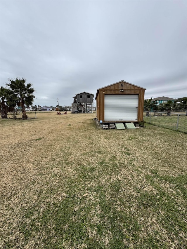 view of yard featuring a garage and an outdoor structure