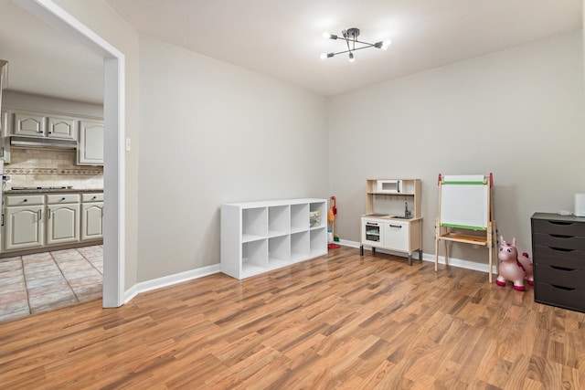 7669 Boardwalk, Lumberton, TX 77657 - rec room featuring light wood-style floors and baseboards