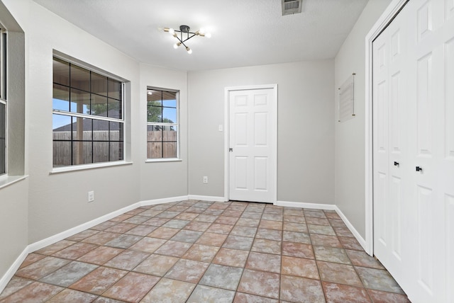 7669 Boardwalk, Lumberton, TX 77657 - unfurnished bedroom featuring stone finish flooring, baseboards, and a closet