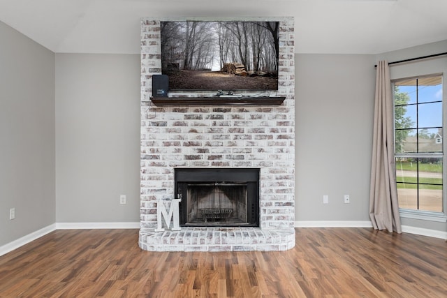 7669 Boardwalk, Lumberton, TX 77657 - detailed view of wood finished floors, baseboards, and a fireplace
