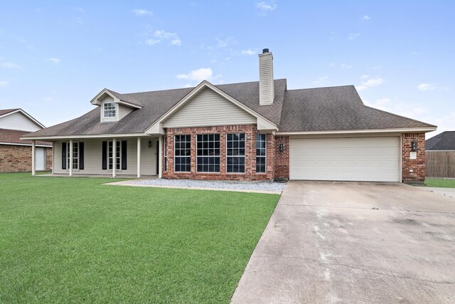 7669 Boardwalk, Lumberton, TX 77657 - view of front of property featuring brick siding, a garage, a front lawn, and driveway