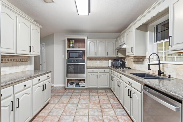 7669 Boardwalk, Lumberton, TX 77657 - kitchen with appliances with stainless steel finishes, a sink, decorative backsplash, and open shelves