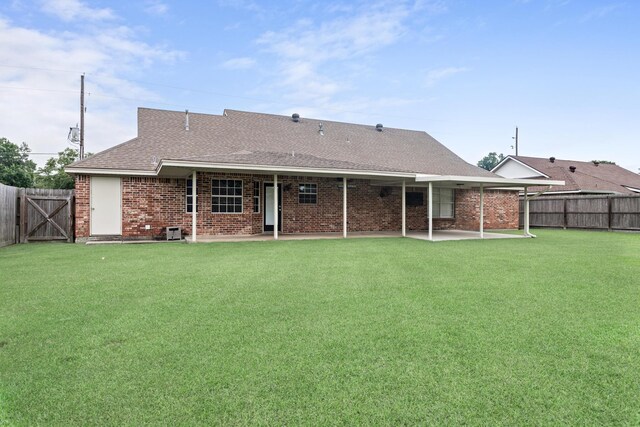 7669 Boardwalk, Lumberton, TX 77657 - rear view of property featuring a patio area, roof with shingles, brick siding, a gate, and central AC