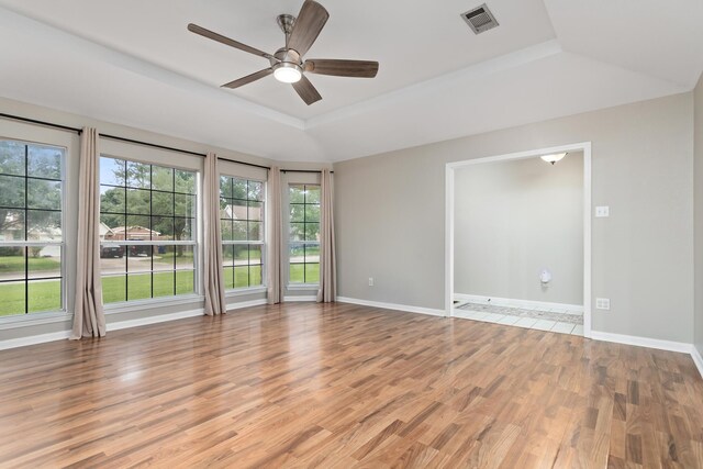 7669 Boardwalk, Lumberton, TX 77657 - unfurnished room featuring a raised ceiling, light wood-style floors, a ceiling fan, and baseboards