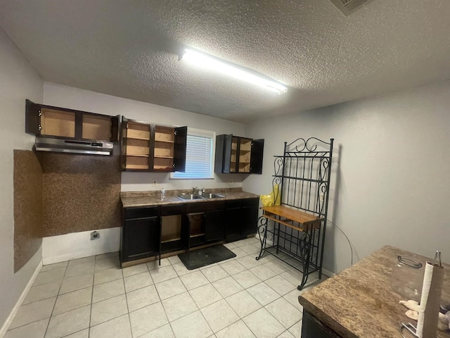 775 Todd St, Beaumont, TX 77707 - kitchen with a textured ceiling, light tile patterned floors, and dark countertops