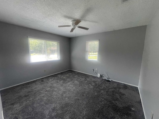 775 Todd St, Beaumont, TX 77707 - spare room featuring ceiling fan, plenty of natural light, dark carpet, and a textured ceiling