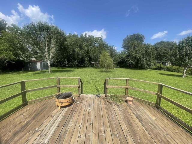 775 Todd St, Beaumont, TX 77707 - wooden deck featuring a yard and a storage shed