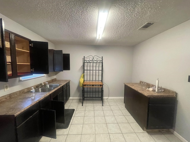 775 Todd St, Beaumont, TX 77707 - laundry area with a textured ceiling and light tile patterned floors