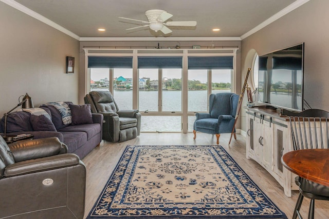 living room with light wood-type flooring, ceiling fan, and crown molding