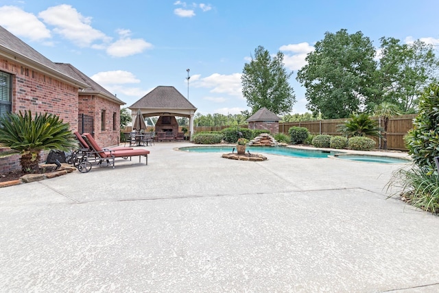 view of pool with a gazebo, a patio area, and an in ground hot tub