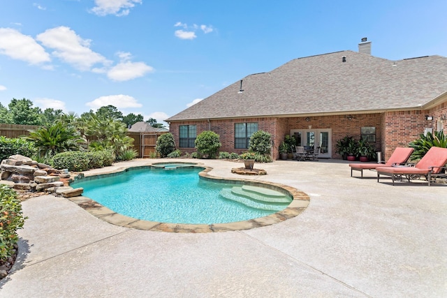 view of pool with a patio, an in ground hot tub, and french doors