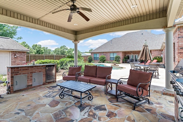 view of patio with a fenced in pool, ceiling fan, wine cooler, an outdoor living space, and area for grilling