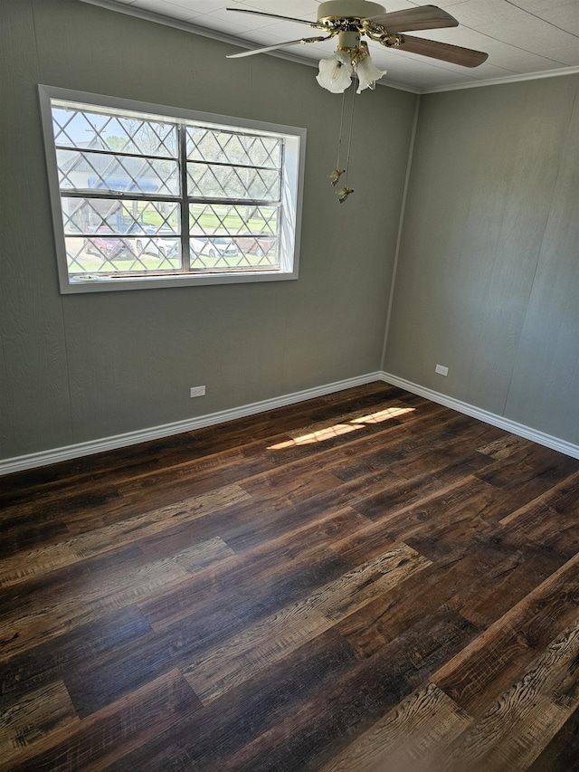 spare room with ceiling fan, dark hardwood / wood-style flooring, and ornamental molding