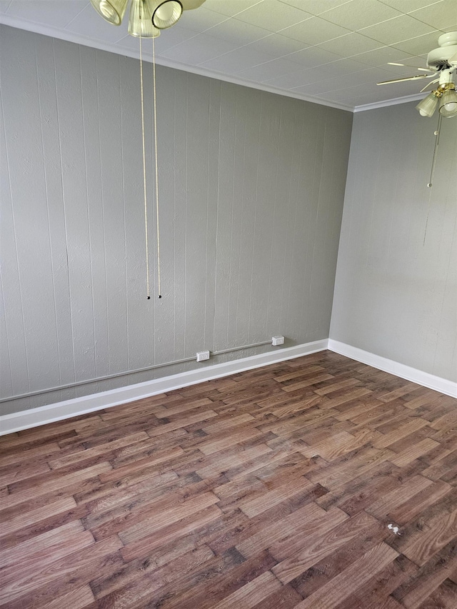 empty room featuring wooden walls and hardwood / wood-style flooring