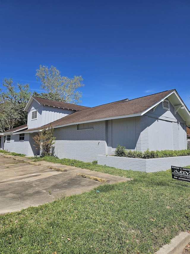 view of side of property with a yard