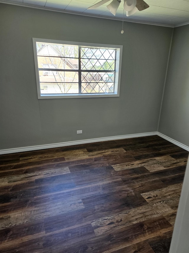 unfurnished room featuring dark hardwood / wood-style floors, ceiling fan, and crown molding