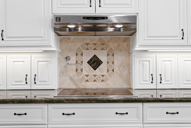 kitchen featuring white cabinets and extractor fan