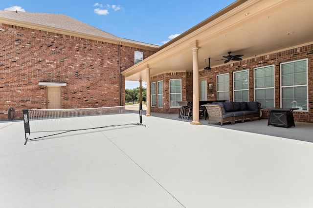 view of patio / terrace featuring outdoor lounge area, tennis court, and ceiling fan